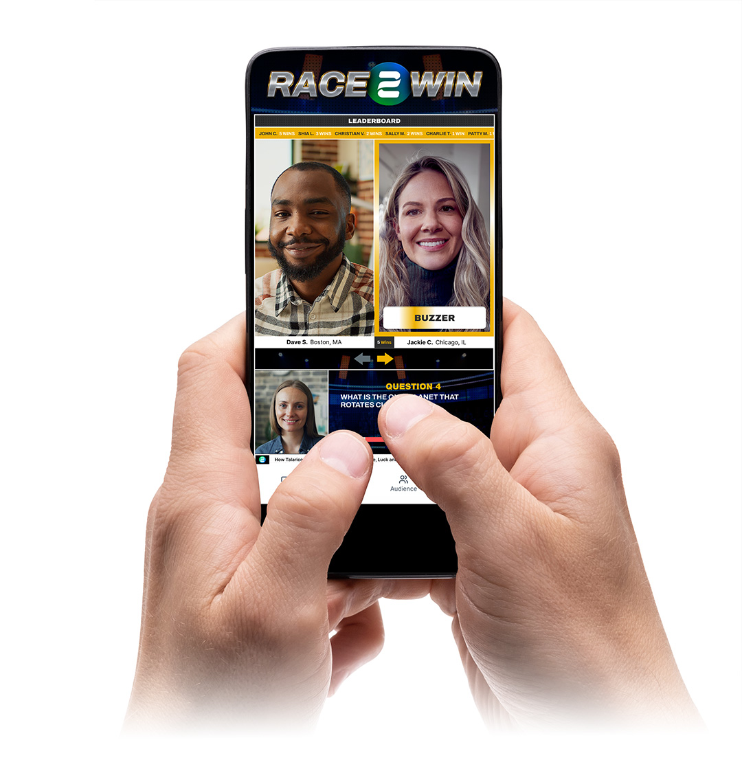 Hand holding a smartphone displaying a split-screen game show with two contestants, a buzzer, and a leaderboard at the top clearly labeled Race 2 Win